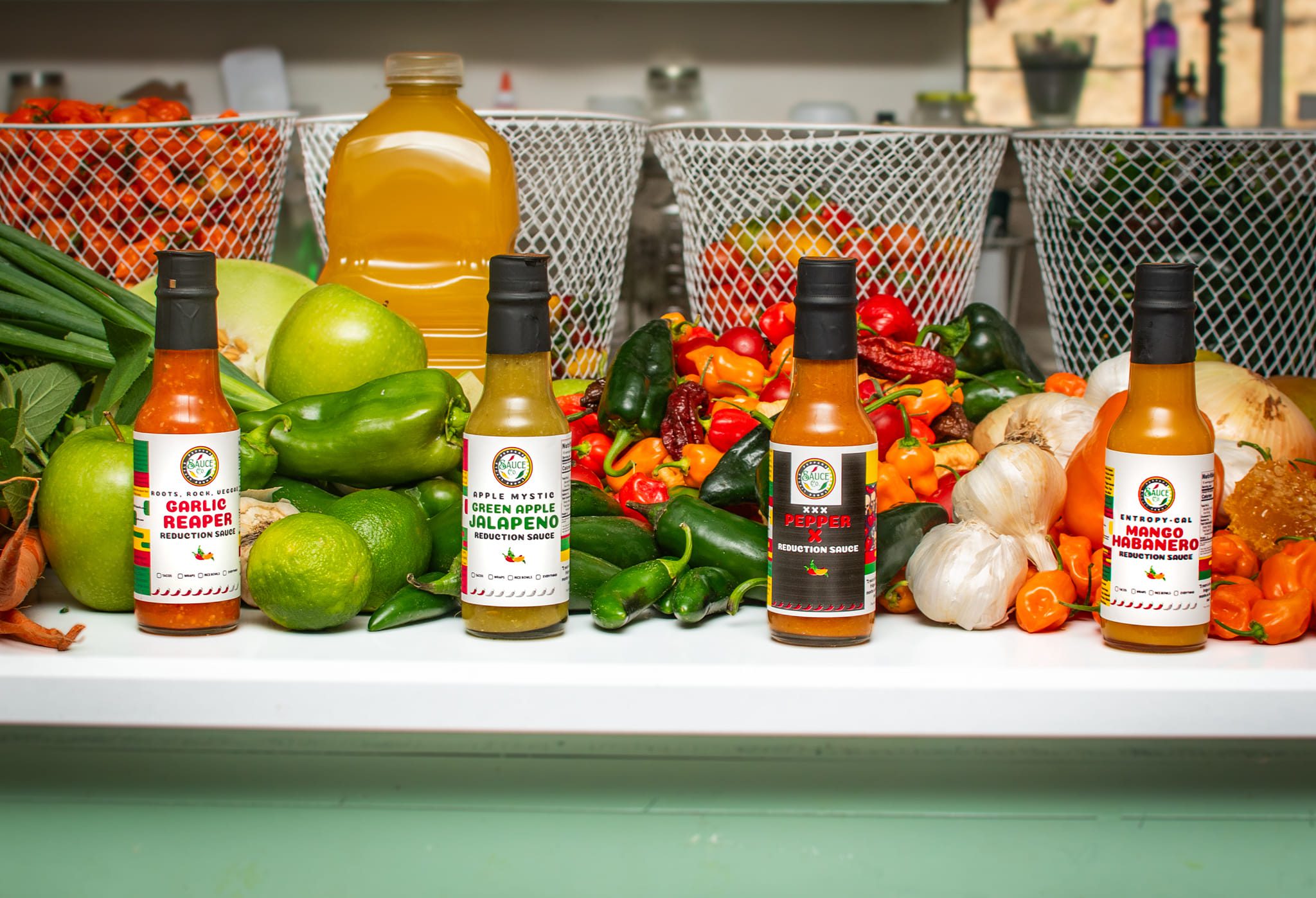 Three Little Peppers sauce lineup with garden produce